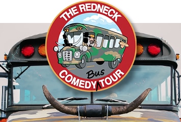 A bus with a decorative bull horn and a "The Redneck Comedy Tour Bus" logo on the front window.