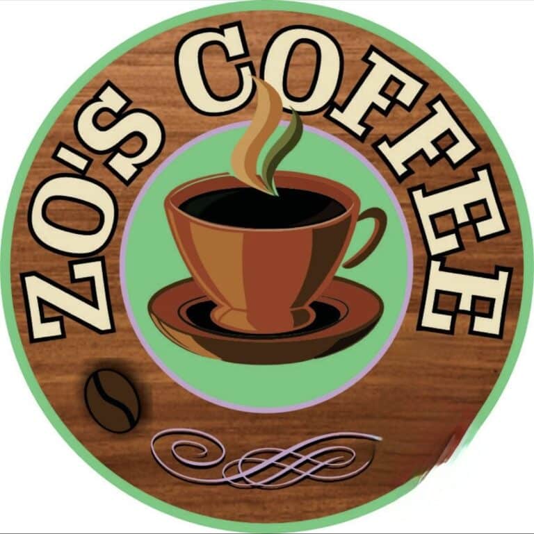 Circular logo for "Zo's Coffee" featuring a steaming coffee cup on a saucer, a coffee bean, and decorative swirls on a wooden background.